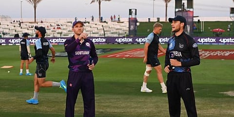 Scotland skipper Richie Berrington (L) with Namibia counterpart Gerhard Erasmus at the toss before a T20 World Cup match. (Photo| Twitter)