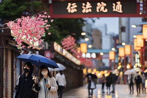 In this April 29, 2021, file photo, people walk through a shopping street along the famed Sensoji temple in the Asakusa neighborhood in Tokyo. (Photo | AP)