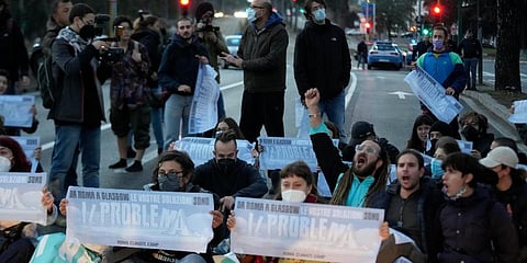 Climate activists try to block traffic in front of the Italian Ministry of the Ecological Transition in Rome on one of the main road leading to La Nuvola convention. (Photo | AP)