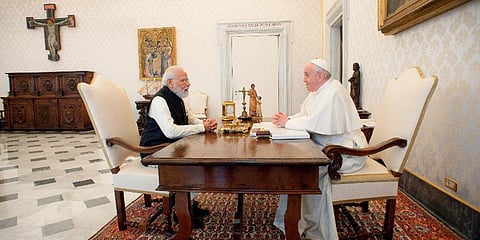 Prime Minister Narendra Modi, left, sits at a table with Pope Francis on the occasion of their private audience at the Vatican, Saturday, Oct. 30, 2021. (Photo | AP)