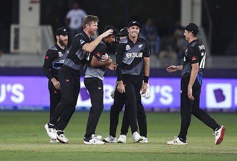New Zealand players congratulate Ish Sodhi, center, for taking India's captain Virat Kohli. (Photo | AP)