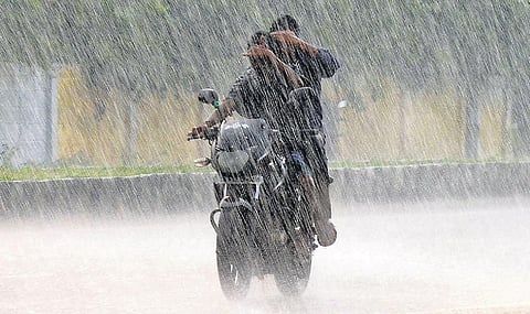 Two youth get drenched at Poonamalle as they ride amid the rain in Chennai. (Photo | Debadatta Mallick, EPS)