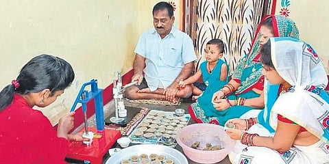 Family members of Nalini Kanta Sahoo busy making cow dung diyas in their house at Mangalabag Mallah Sahi in Cuttack. (Photo | EPS)