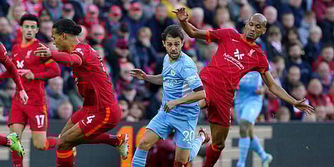 Manchester City's Bernardo Silva, center, battles with Liverpool's Virgil van Dijk, left, and Fabinho during the EPL match at Anfield, Liverpool, England. (Photo | AP)