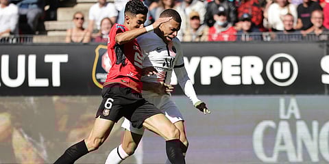 PSG's Kylian Mbappe (R) is challenged by Rennes' Nayef Aguerd during a French League One match at the Roazhon Park stadium in Rennes. (Photo| AP)