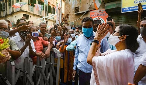 West Bengal Chief Minister Mamata Banerjee greets her supporters during her visit to religious places, at Bhabanipur in Kolkata. (Photo | PTI)