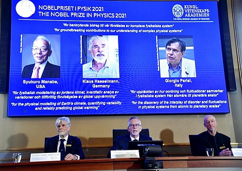 Winners of the 2021 Nobel Prize in Physics being announced at the Royal Swedish Academy of Sciences, in Stockholm. (Photo | AP)