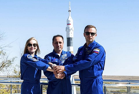 Actress Yulia Peresild, left, director Klim Shipenko' right, and cosmonaut Anton Shkaplerov, members of the prime crew of Soyuz MS-19 spaceship pose at the Russian launch facility. (Photo | AP)