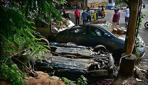 Vehicles damaged at HAL, Ramesh Nagar, after a part of a compound wall collapsed during Sunday’s rain. (Photo | Ashishkrishna HP)