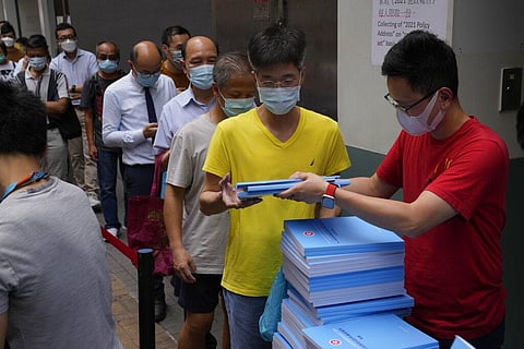 People line up to collect the copies of the policy address after Hong Kong Chief Executive Carrie Lam delivering her policy address at the Legislative Council. (Photo | AP)