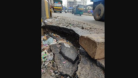 Due to a sinkhole caused by water beneath the Bengaluru-Mysuru highway, a portion of road caved in near a pillar of the Jnanabharathi Metro station.(Photo | Express)