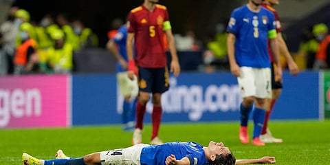Italy's Federico Chiesa lies on the pitch at the end of the UEFA Nations League semifina match against Spain in Milan. (Photo| AP)
