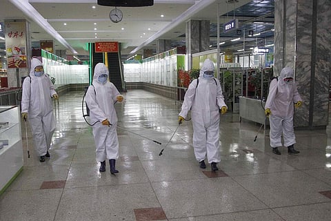 Staff of the Pyongyang Department Store No. 1 disinfect the store to help curb the spread of the coronavirus. (Photo | AP)