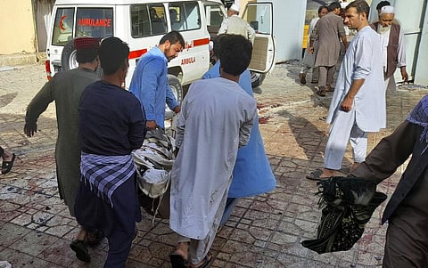 People carry the body of a bombing victim in Kunduz province, northern Afghanistan, Friday, Oct. 8, 2021. (Photo | AP)