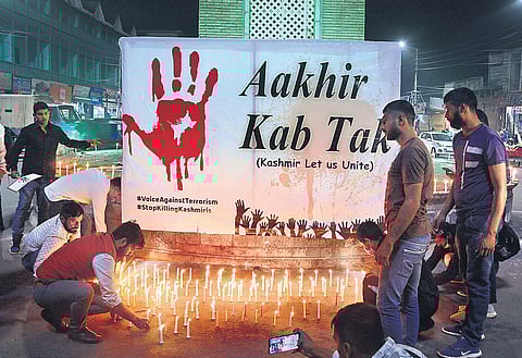 Kashmiri Pandits take part in a candle light protest against the killing of civilians belonging to minority communities in Srinagar. (File Photo | PTI)