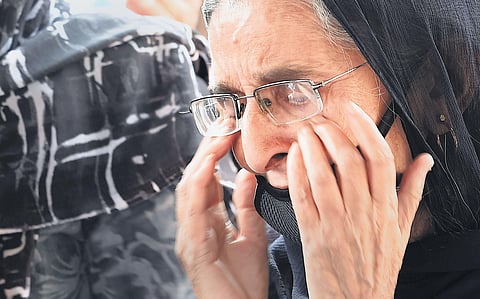 A relative wails during the funeral of Satinder Kaur, slain government school principal, in Srinagar on Friday | PTI