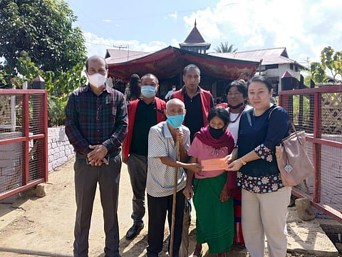Extra Assistant Commissioner Limakumla doing her noble deed by handing over some money to an elderly couple on the occasion. (Photo | Special arrangement)