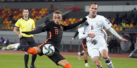 Latvia's Eduards Emsis (R) fights for the ball with Netherlands' Noa Lang. (Photo | AP)