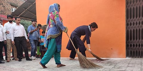 Congress leader Priyanka Gandhi (Right) sweeping at Luv Kush Nagar, a Dalit hamlet in Lucknow, Oct 8, 2021. (Photo | Twitter, INC India)