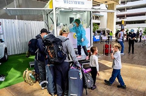 Arriving passengers wait for PCR test to be taken at the Phuket International Airport as Thailand welcomes the first group of tourists fully vaccinated against the Covid (Photo | AFP)