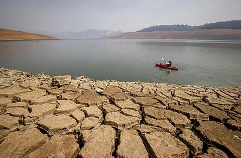A kayaker paddles in Lake Oroville as water levels remain low due to continuing drought conditions in Oroville, California. (Photo | AP)