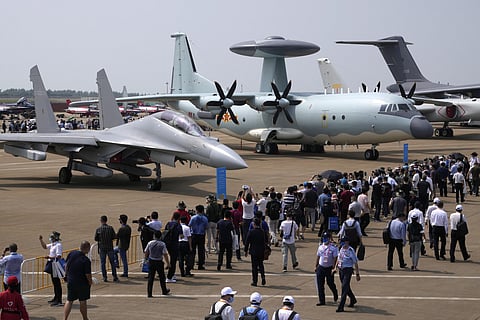 FILE - Visitors view the Chinese military's J-16D electronic warfare airplane, left, and the KJ-500 airborne early warning and control aircraft. (File photo | AP)