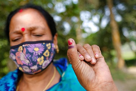 A voter displays the indelible ink mark on her finger after casting her vote in Srinagar, Munshiganj district, Bangladesh. (Photo | AP)