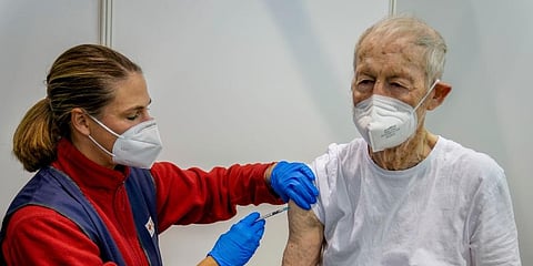 An 87-year-old man receives his booster shot at the vaccination center in Frankfurt, Germany. (Photo | AP)