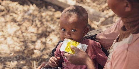 A mother giving supplementary nutrition products to her 6-month-old daughter in Ankilimanondro. (Photo | AP)