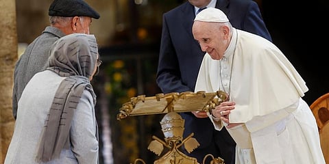 Pope Francis greets Abdul Razaq Quadery, left, and his wife Salima, second from left, two refugees from Afghanistan. (Photo | AP)