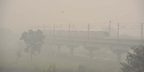 A Metro train makes its way amid low visibility due to a thick layer of smog, in New Delhi on Friday. (Photo | Shekhar Yadav/EPS)