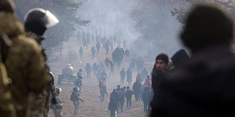 Belarusian servicemen guard an area as migrants gather at the Belarus-Poland border near Grodno, Belarus. (Photo | AP)