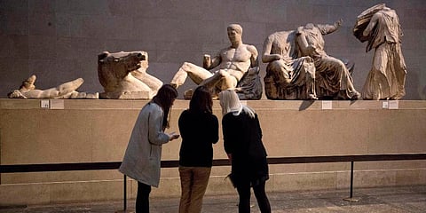 Women stand by a marble statue of a naked youth thought to represent Greek god Dionysos. (Photo | AP)