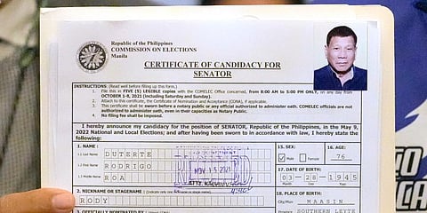 A representative of Philippine President Rodrigo Duterte holds his Certificate of Candidacy for Senator at the Commission on Elections in Manila, Philippines. (Photo | AP)