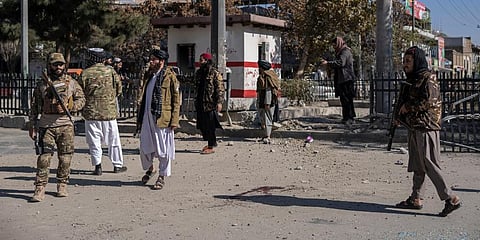 Taliban fighters secure the area after a roadside bomb went off in Kabul Afghanistan. (Photo | AP)