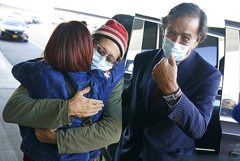 Danny Fenster, center, hugs his mother Rose Fenster as former U.S. diplomat Bill Richardson, right, looks on at John F. Kennedy Airport in New York, Tuesday, Nov. 16, 2021. (Photo | AP)