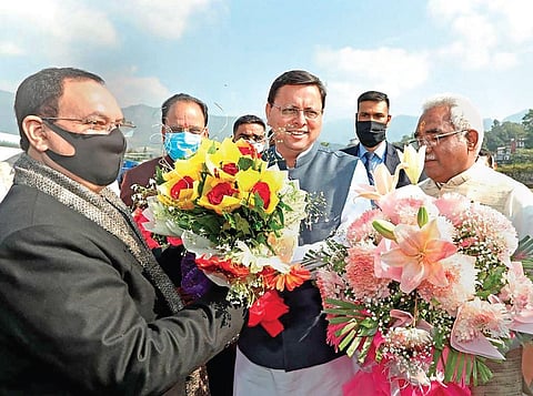 Uttarakhand Chief Minister Pushkar Singh Dhami welcomes BJP national president J P Nadda on his arrival in Dehradun on Monday. (Photo | PTI)