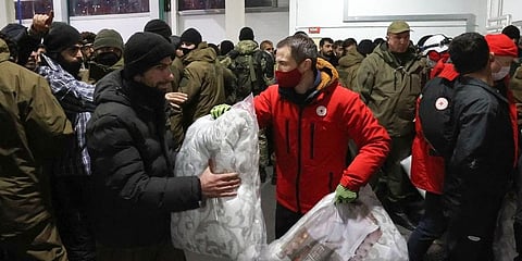 Migrants settle for the night in the logistics center in the checkpoint 'Kuznitsa' at the Belarus-Poland border near Grodno. (Photo | AP)