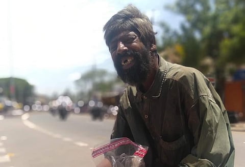 Basappa alias Huccha Bashya from Hoovina Hadagali Taluk sits near the bus stand. (Photo | EPS)