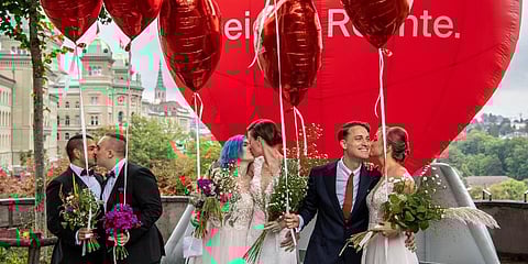 Operation Libero stages a photo opportunity of a marriage with three different couples, in Bern. (Photo | AP)