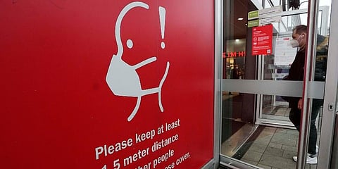 A sign reminds of mandatory face masks at the train station in Cologne, Germany. (Photo | AP)