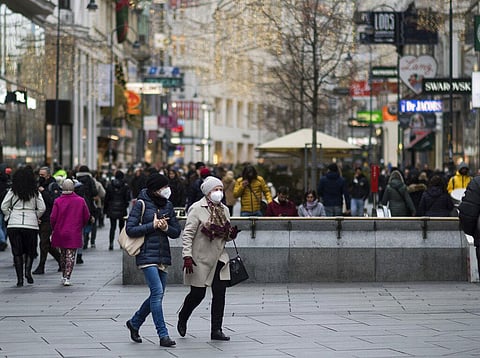 People wearing face mask to protect against the coronavirus as they walk at a shopping street in Vienna, Austria (Photo | AP)