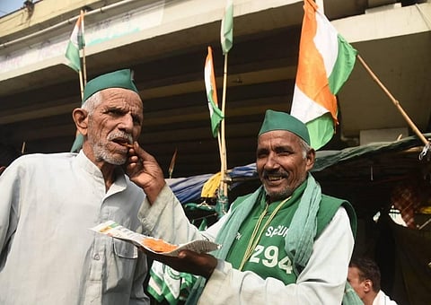 Farmers celebrating and distribute sweets after PM Modi decided to repeal all three farm laws, at Ghazipur border in New Delhi on Friday. (Photo | Parveen Negi/EPS)