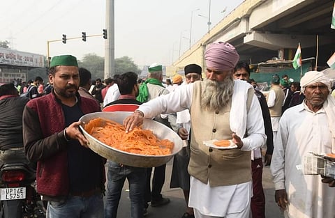 Farmers celebrating and distribute sweets after PM Modi decided to repeal all three farm laws,at Ghazipur border in New Delhi on Friday. (Photo | Parveen Negi/EPS)