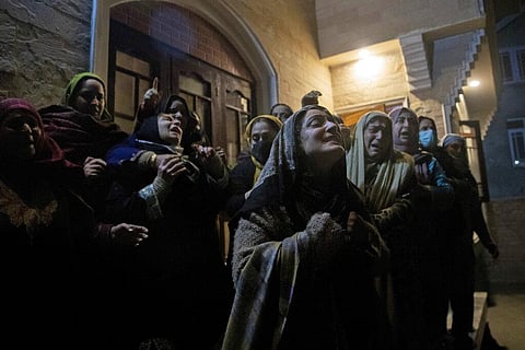 Relatives and neighbours of Mohammad Altaf Bhat, a shopping center owner who was among four people killed in a deadly raid. (Photo | AP)