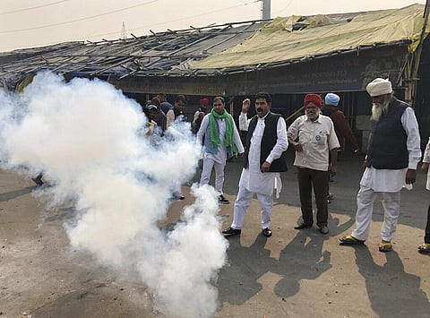 Farmers light firecrackers to celebrate news of the repeal of farm laws they were protesting against, in Ghazipur. (Photo | AP)