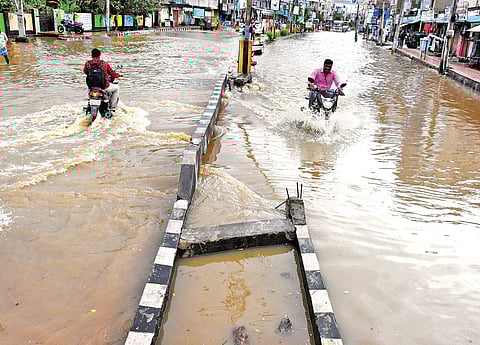 People wade through an inundated West Church Road and Lakshmipuram Circle in Tirupati on Thursday. (Photo | Madhav K)
