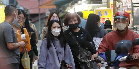 People wear face masks to protect against the spread of the coronavirus in an outdoor market in Taipei, Taiwan. (Photo | AP)