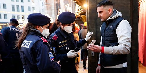 Police officers check the vaccination status of visitors during a patrol on a Christmas market in Vienna, Austria. (Photo | AP)