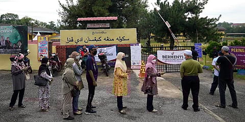 Voters line up to enter a voting center on the outskirts of Malacca, Malaysia, Saturday, Nov. 20, 2021. (Photo | AP)
